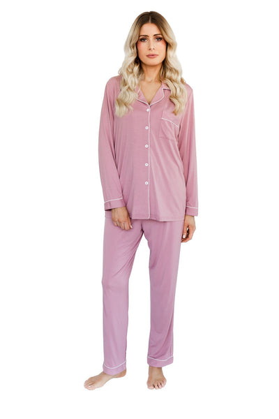 A photo of a woman in a pink bamboo pyjama set, ideal for women's sleepwear that combines comfort and eco-friendliness through the use of sustainable bamboo fibers